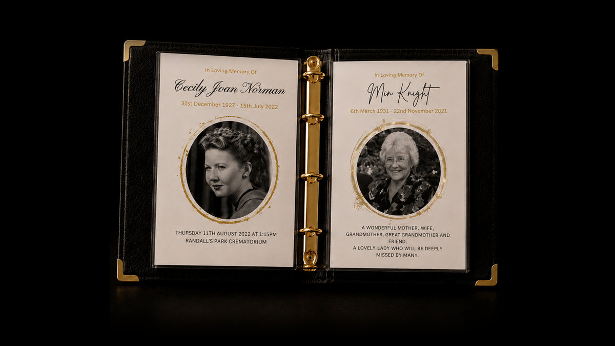 An open Record of Respect album with gold ring binding and gold corners, showing two In Loving Memory pages with black-and-white portraits framed by gold circles