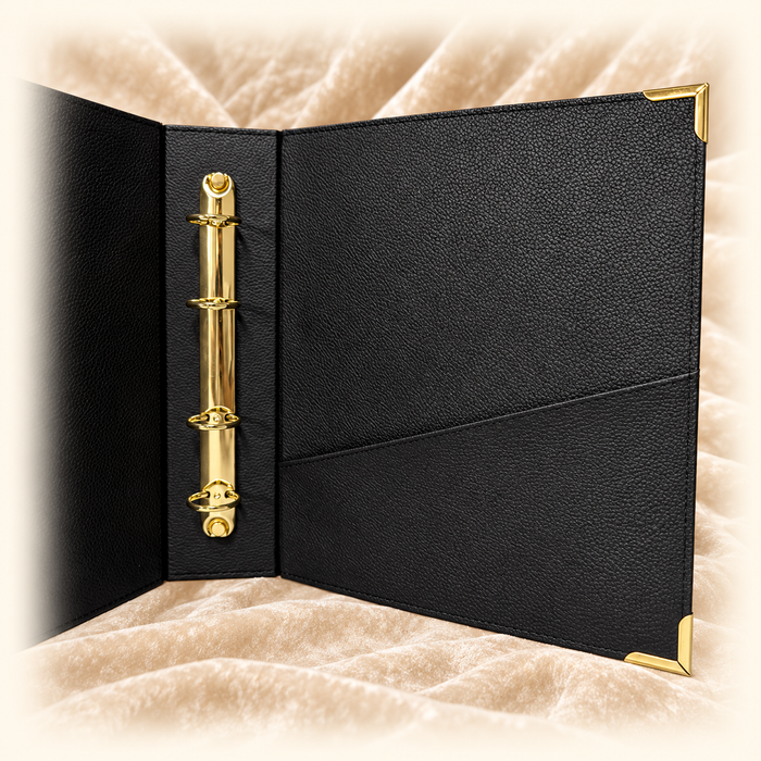Close view of the Record of Respect album's gold ring binder mechanism and internal document pockets