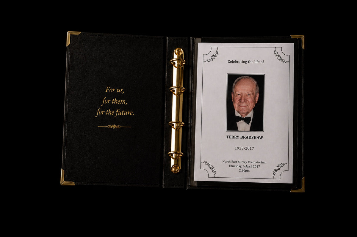 Open Record of Respect black leatherette memorial album with gold ring binder and corners, showing an Order of Service booklet inside its protective sleeve, against a dark background