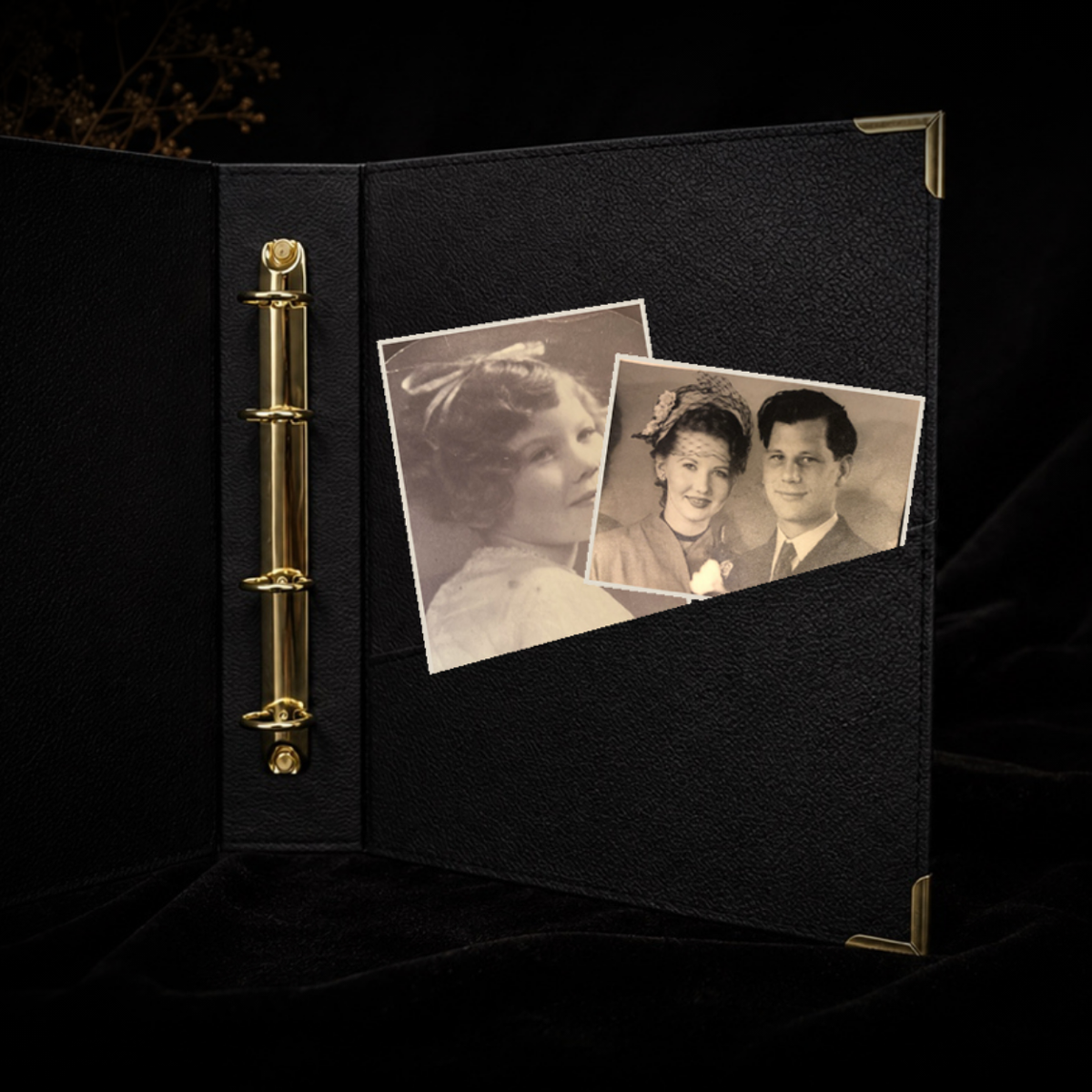 Open Record of Respect album showing its gold ring binding and full-width back pocket holding a pressed-flower card and a black-and-white photograph